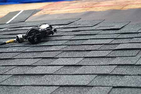 Asphalt shingles with a nail gun